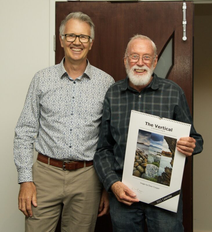 Mal receives a calendar as an honorary award for one of his images